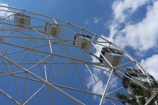 Beautiful and modern Ferris wheel on blue sky background. Evpatoria, Crimea