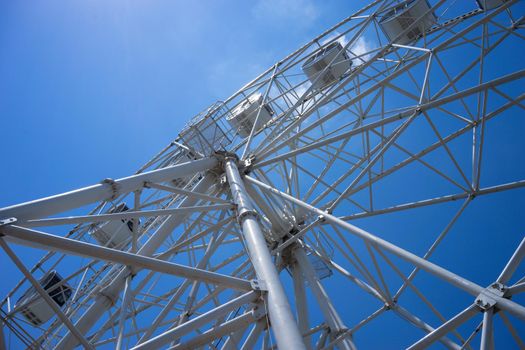 Beautiful and modern Ferris wheel on blue sky background. Evpatoria, Crimea