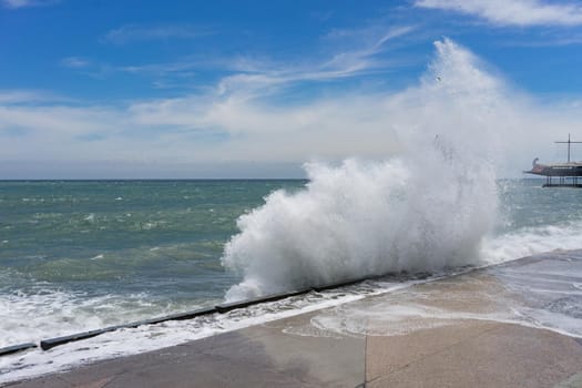 seascape with high waves on the background of the coastline of Yalta, Crimea.