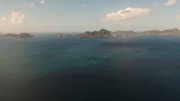 Bay and the tropical islands. Seascape with tropical rocky islands, ocean blue wate, aerial view. islands and mountains covered with tropical forest. El nido, Philippines, Palawan. Tropical Mountain Range