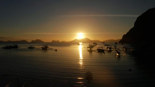 aerial view Sea bay with boats at sunset. Sunset over the sea with islands. Busuanga, Palawan, Philippines