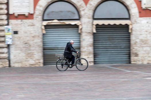terni ,italy february 12 2021:man panning on bicycle in the city