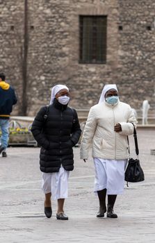 terni ,italy february 12 2021:nuns out for a walk in the center of terni