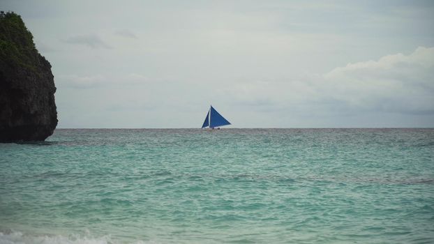 Sailing boat on sea. Sailing ship yachts with blue sails in the ocean. Sailing ship yachts in the sea. Philippines, Boracay. Travel concept.