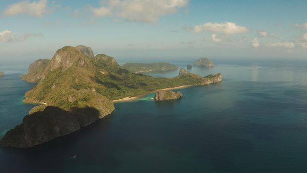 Cove with tropical rocky islands covered with rainforest, sea with blue water, aerial view. El nido, Philippines, Palawan. Tropical Mountain Range