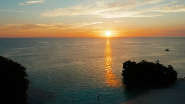 Colorful bright clouds during sunset over the sea, aerial view. Sunset over ocean. Boracay, Philippines. Seascape, Summer and travel vacation concept