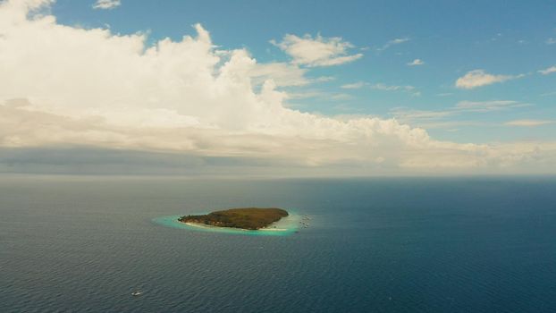 Tropical island with sandy beach in the blue sea, aerial view. Small island with sandy beach. Summer and travel vacation concept, Sumilon island, Philippines.