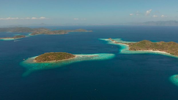 aerial drone tropical islands with blue lagoons, coral reef and sandy beach. Palawan, Philippines. Islands of the Malayan archipelago with turquoise lagoons.