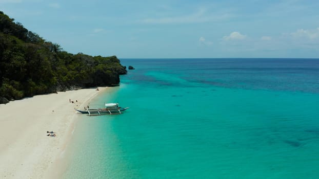 Tropical beach with palm trees and turquoise waters of the coral reef, top view, Puka shell beach. Boracay, Philippines. Seascape with beach on tropical island. Summer and travel vacation concept.