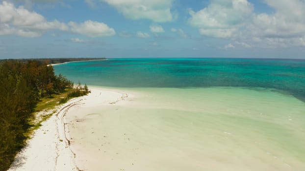 Tropical island with sandy beach by atoll with coral reef and blue sea, aerial view. Bugsuk Island with sandy beach. Summer and travel vacation concept.