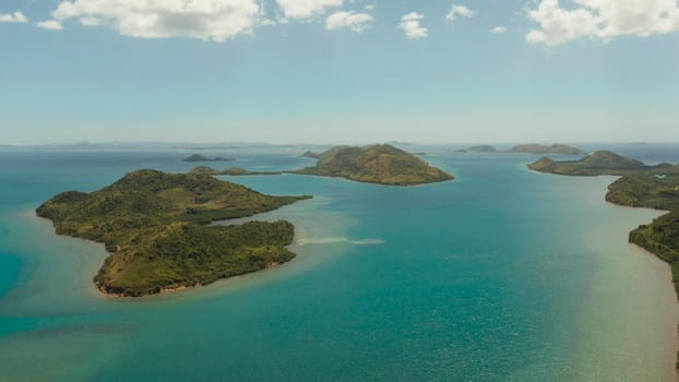 aerial view small island group in province of Palawan. Busuanga, Philippines. Seascape, islands covered with forest, sea with blue water. tropical landscape, travel concept