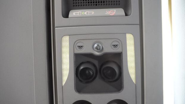 Overhead console of conditioner in a airplane. Fasten Seat belt. Symbol sign that be lighting for security on every flight trip