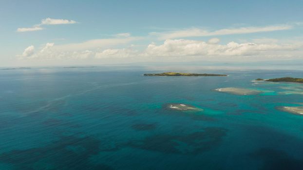 Tropical islands in turquoise lagoon and coral reef water, aerial view. Bucas grande, Philippines. Summer and travel vacation concept.