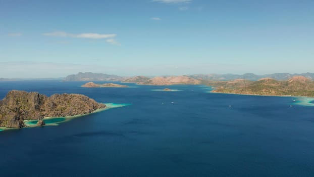aerial view tropical islands with blue lagoons, coral reef and sandy beach. Palawan, Philippines. Islands of the Malayan archipelago with turquoise lagoons.