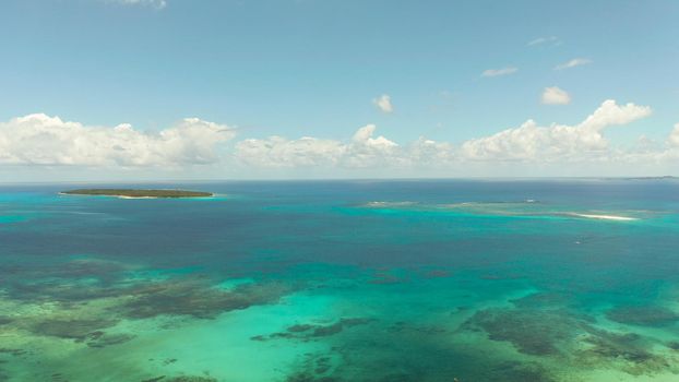 Seascape: Blue sky with clouds over the sea with islands, aerial view. Summer and travel vacation concept. Siargao,Philippines.
