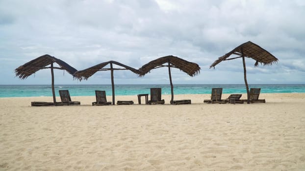 Beach with deck chairs, sun beds, umbrellas.Beach, sea, sand,wave. Seascape ocean and beautiful beach paradise, blue sky, clouds. Philippines Travel concept