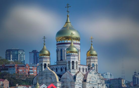 Vladivostok, Russia. The building of the temple under construction against the blue sky.