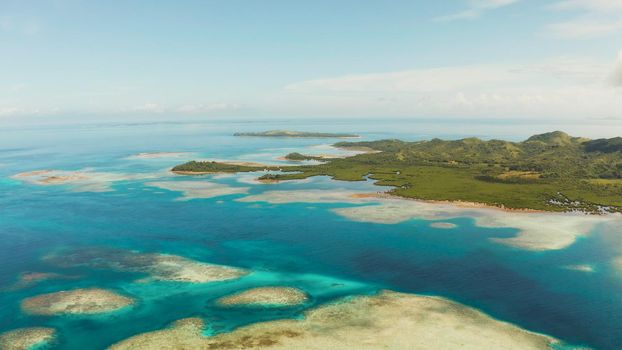Seascape: Tropical Islands with beaches and azure coral reef water from above. Bucas grande, Philippines. Summer and travel vacation concept.