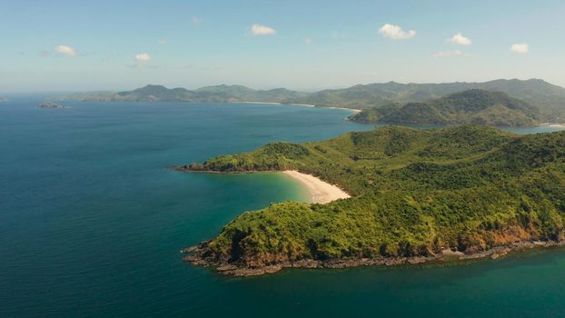 Sandy beach on tropical island, aerial view. El nido, Philippines, Palawan. Seascape with tropical island, ocean blue water. Summer and travel vacation concept