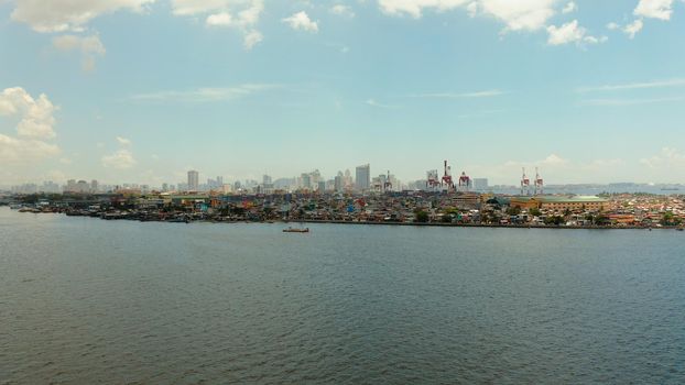 Sea port on the background of the city of Manila with skyscrapers and modern buildings. Modern buildings in the city center.