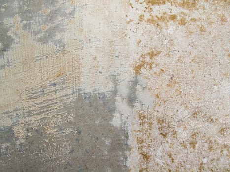 The wall is gray in color with a damaged surface and roughness in close-up.Texture or background