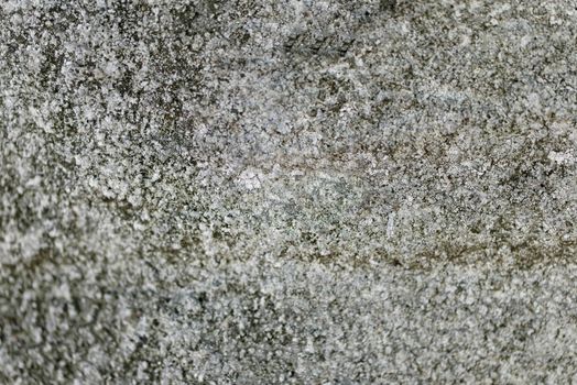 Close-up of a solid wall of rough gray cement with uneven depressions.Texture or background