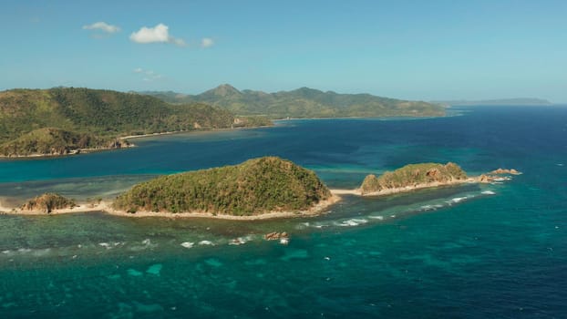 aerial view tropical island in blue lagoon, coral reef and big wave. Palawan, Philippines. tropical landscape ,travel concept