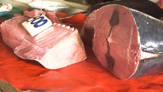 Fresh Tuna fish in Asian market. Sale of fresh sea fish in the Asian public store. Sea fish lying on the shopboard at one of the street markets. Philippines.