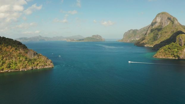 Cove with tropical rocky islands covered with rainforest, sea with blue water, aerial view. El nido, Philippines, Palawan. Tropical Mountain Range