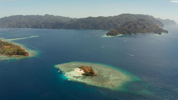 aerial view tropical island with sand white beach, clear and blue water. CYC Beach, Philippines, Palawan. Tropical landscape with blue lagoon, coral reef. travel concept