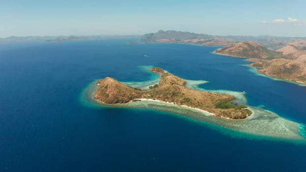 Aerial drone tropical islands with blue lagoons, coral reef and sandy beach. Palawan, Philippines. Island Busuanga of the Malayan archipelago with turquoise lagoons.