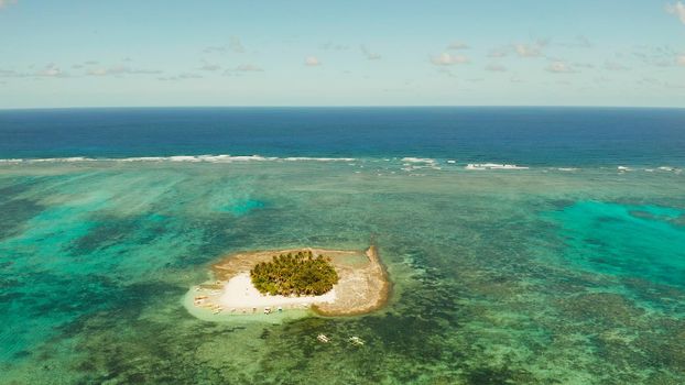Travel concept: sandy beach on a small island by coral reef atoll from above. Guyam island, Philippines, Siargao. Summer and travel vacation concept.