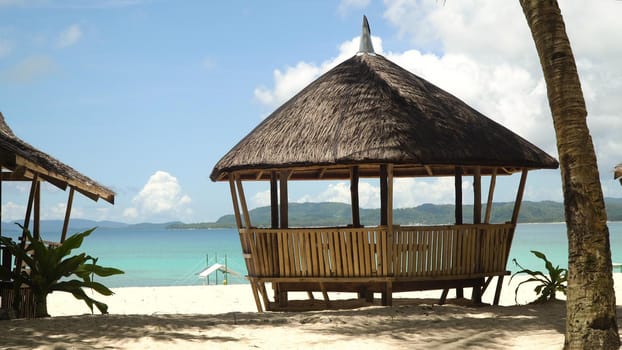 Beach with white sand with beach house on a tropical island Daco. Beautiful sky, sea, resort. Seascape: Ocean and beautiful beach paradise. Philippines. Travel concept.