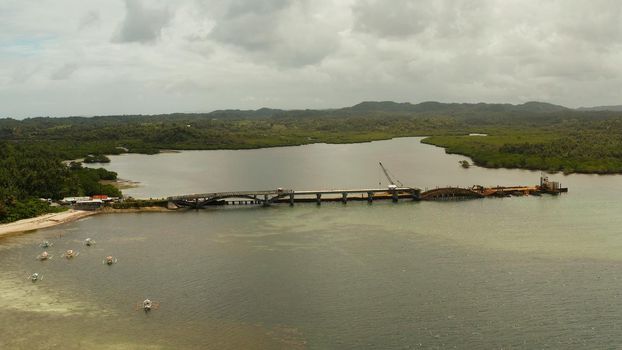 Bridge under construction over the sea bay connecting the two parts of Siargao island.