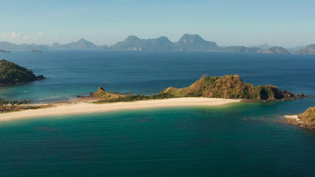 Tropical island with sandy beach, aerial view. Nacpan, El Nido, Palawan, Philippine Islands. Seascape with tropical beach and islands. Summer and travel vacation concept