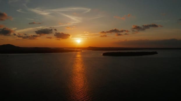 Colorful sunset over tropical islands, aerial view. Sunset over ocean. Balabac, Palawan, Philippines