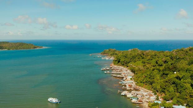 Village of stilt houses built over the sea, top view. City and port on Balabac Island, Palawan, Philippines.