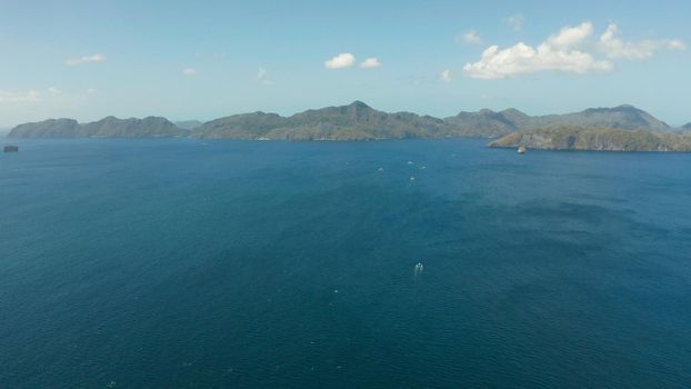 Aerial drone of Seascape with tropical rocky islands, blue water. islands and mountains covered with tropical forest. El nido, Philippines, Palawan