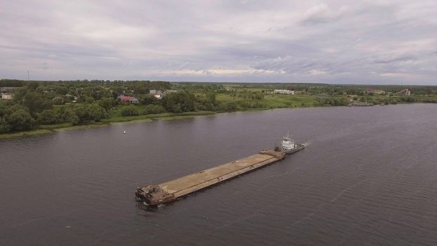 Aerial view:river barge on the beautiful river.Aerial:Cargo ship on the river Volga.