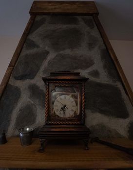 Antique wooden clock on a slate stone background