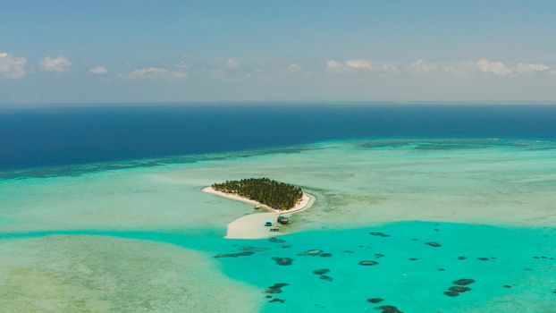 Tropical landscape: small island with beautiful beach, palm trees by turquoise water view from above. Onok Island, Balabac, Philippines. Summer and travel vacation concept