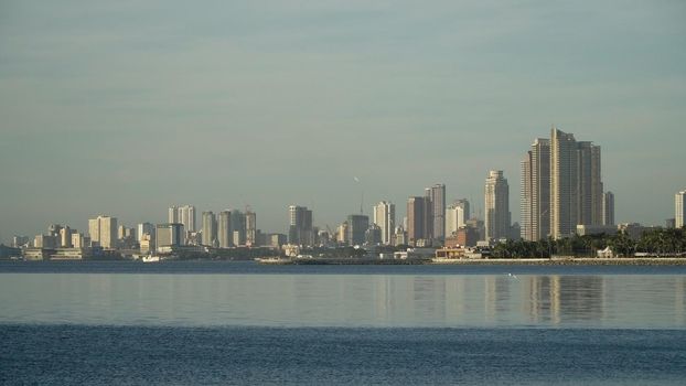 Manila city, skyscrapers and buildings. Seascape coastal city of Manila. Modern city by sea. Makati district. Travel concept.