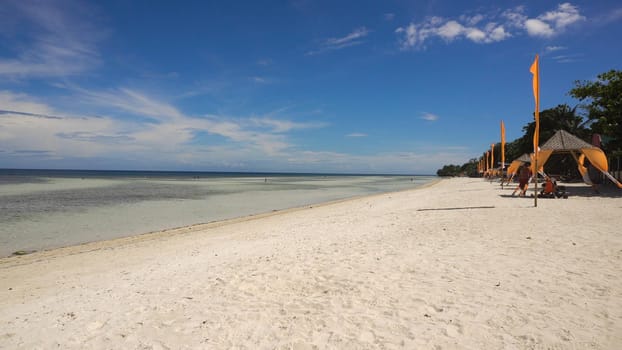 Tropical beach with white sand with beach house on a tropical island Bohol . Beautiful sky, sea. Seascape: Ocean and beautiful beach paradise. Philippines. Travel concept.