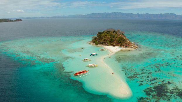 aerial view tropical island with sand white beach. Bulog Dos, Philippines, Palawan. Seascape bay with turquoise water and coral reef.