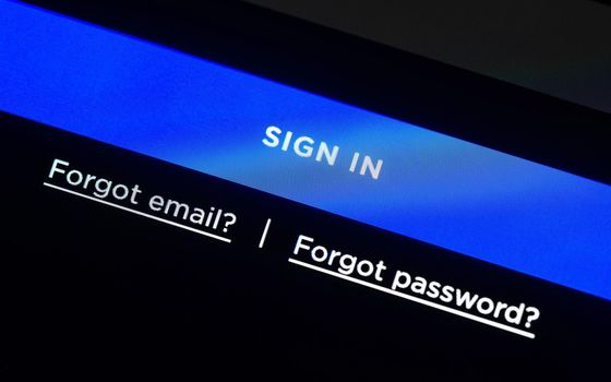 Blue sign in button on LCD screen, login web page, two links for forgotten email and password.