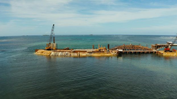 Bridge under construction over the sea bay connecting the two parts of Siargao island.