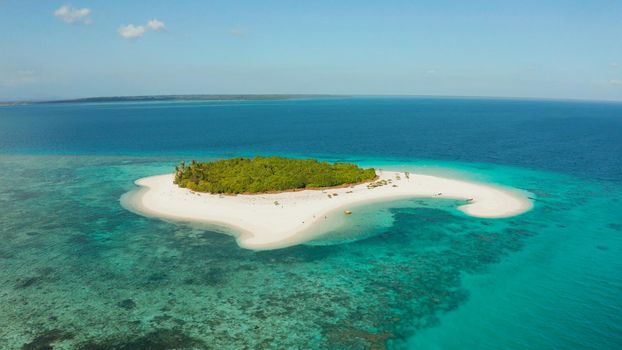 Sandy beach and tropical island by atoll with coral reef and axure water, top view. Patawan island with sandy beach. Summer and travel vacation concept.