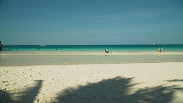 Tropical beach with tourists and clear blue sea. Summer and travel vacation concept. Boracay, Philippines