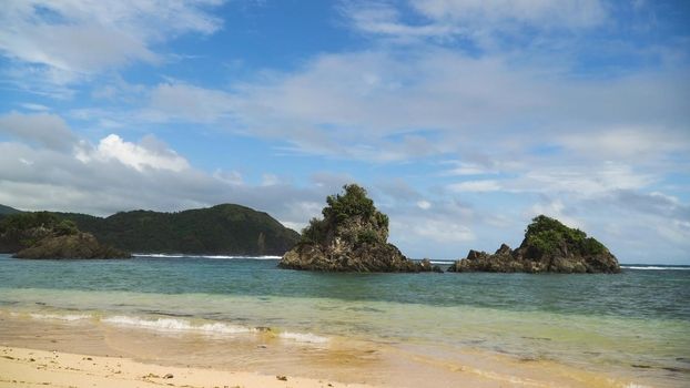 Seascape with beach, rocks and wave, sky, clouds, rocks, ocean. Puraran. 4K video Philippines Catanduanes Travel concept