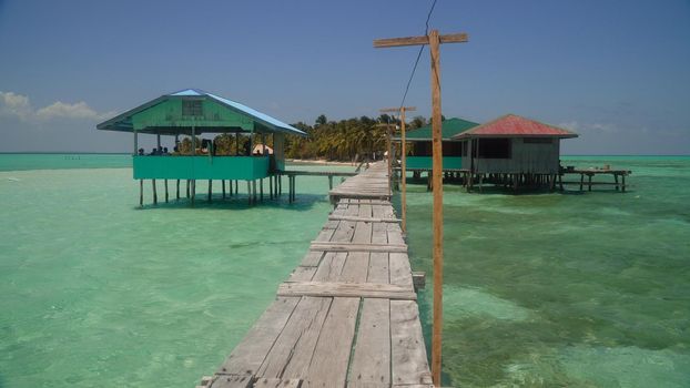 A pier with wooden arbors on a tropical island. Onok Island, Balabac, Philippines. Summer and travel vacation concept